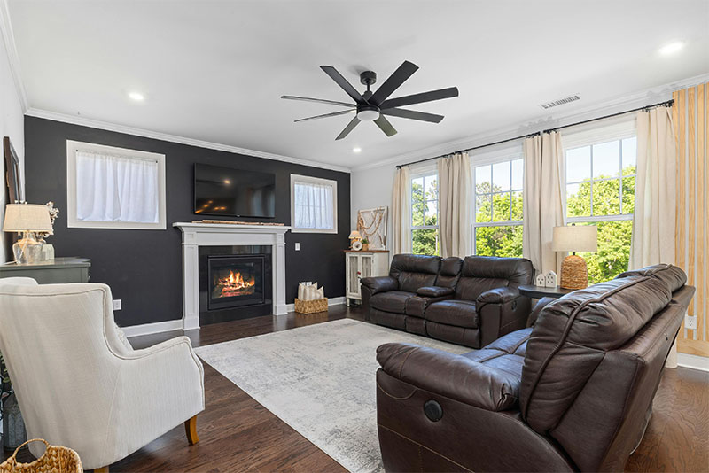 living room with a lit fireplace